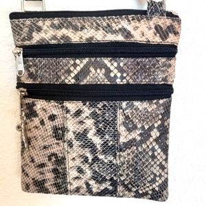 Black and cream fuax snake pattern shoulder  with five total compartments.